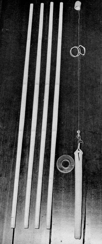 In black and white, parts of a shinai laid out on the floor.